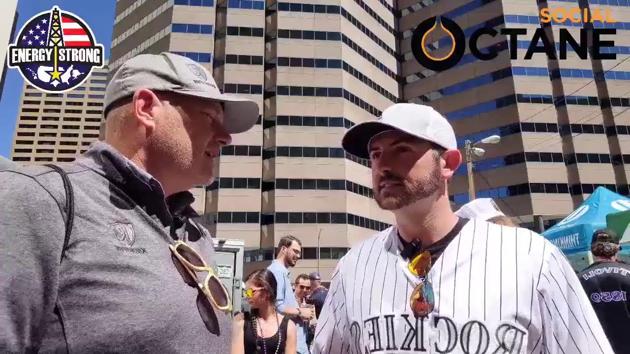 Two energy professionals recording a conversation at a tailgate party